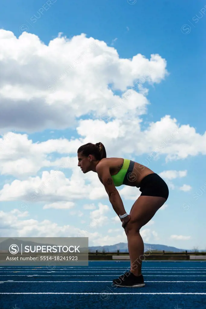 Tired female runner on a field