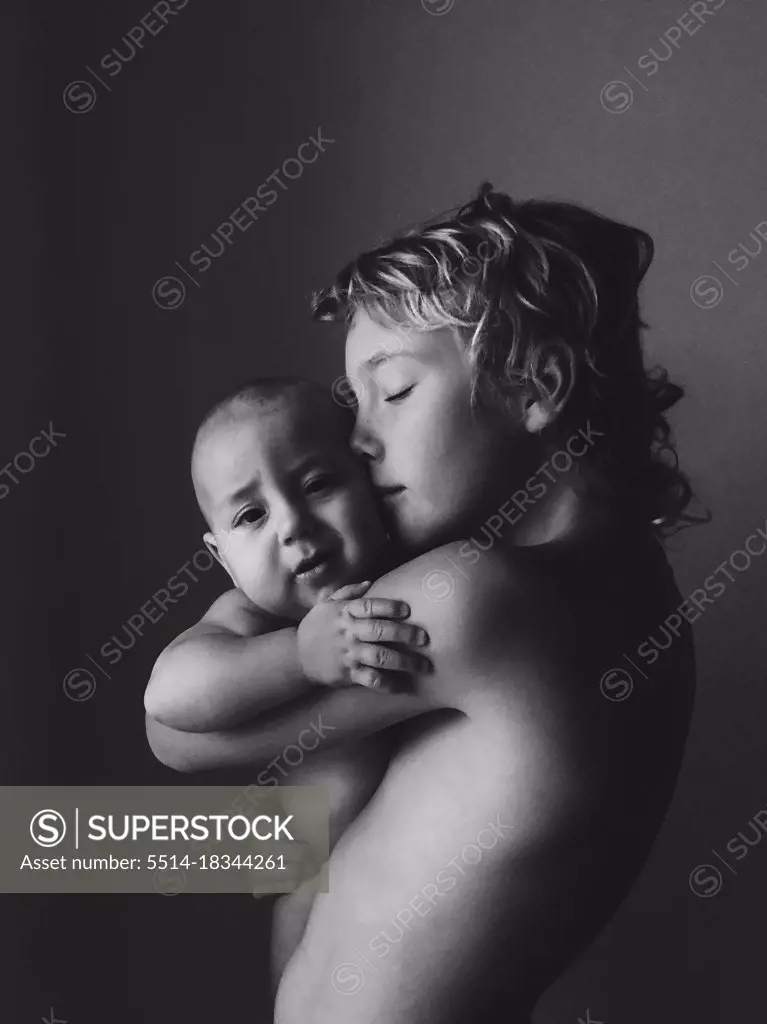 Brothers are holding each other with tenderness