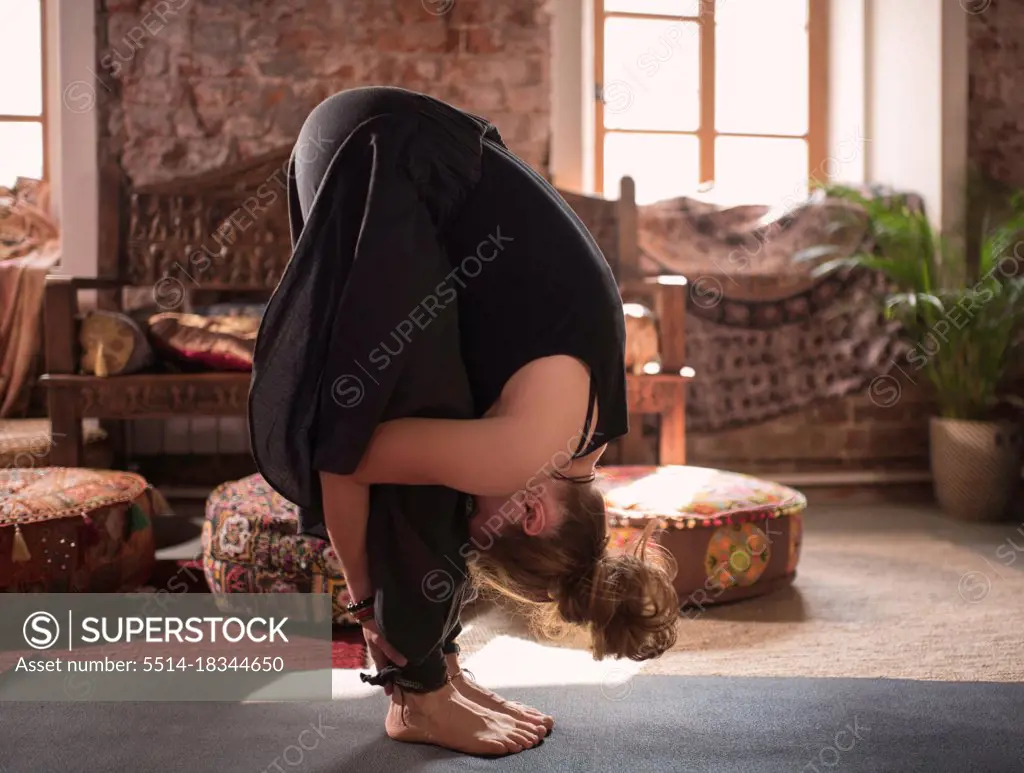 Woman doing Standing Forward Bend pose