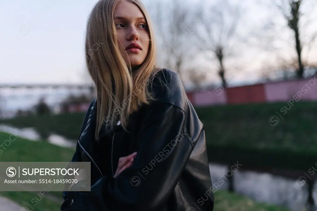 Woman in a leather jacket at sunset