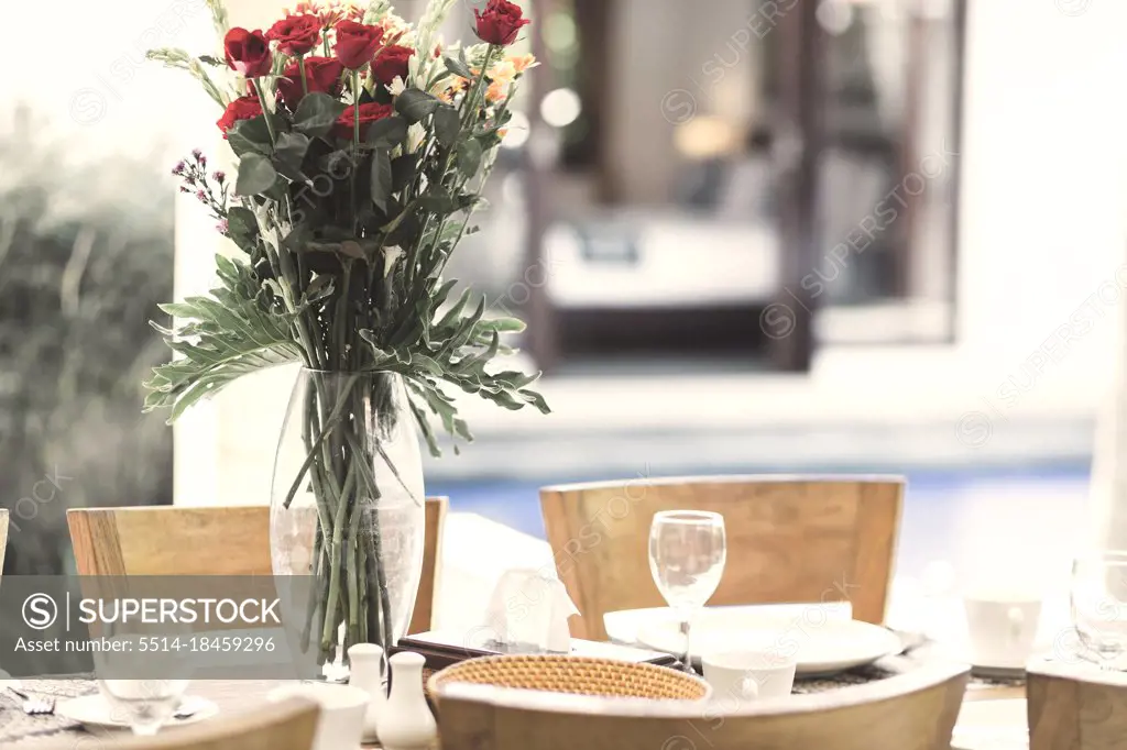 Flower bouquet at the table and pool in background