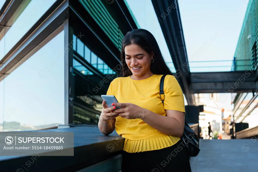 Beautiful young business woman using her phone