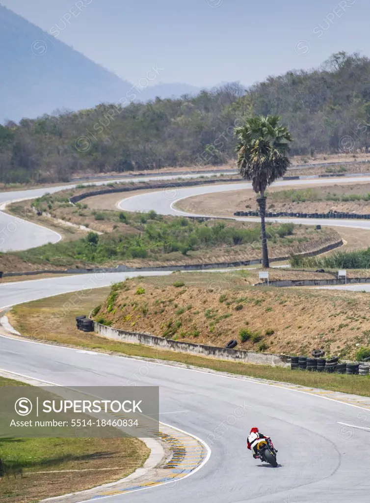 man practising laps on race track with his motorcycle