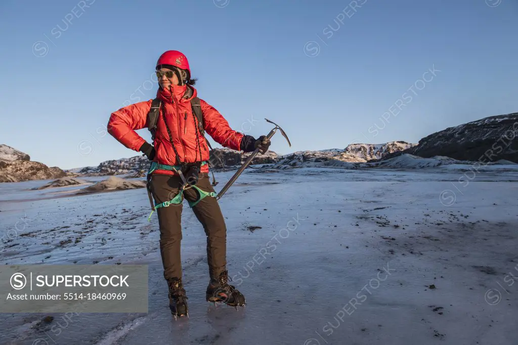 woman posing with ice pick on glacier in Iceland