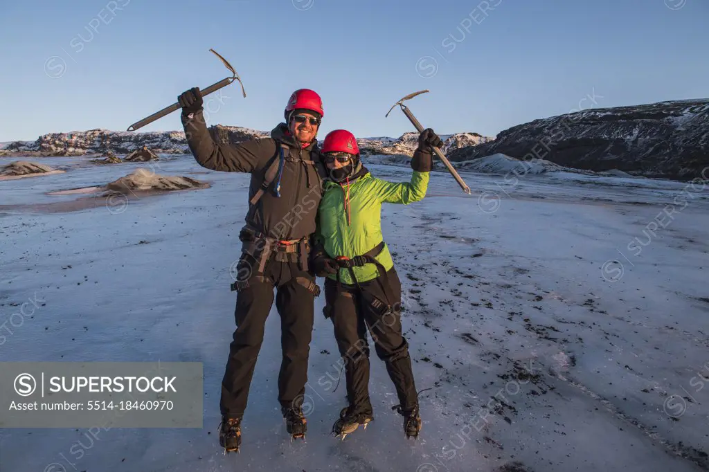 couple posing with ice pick on glacier in Iceland