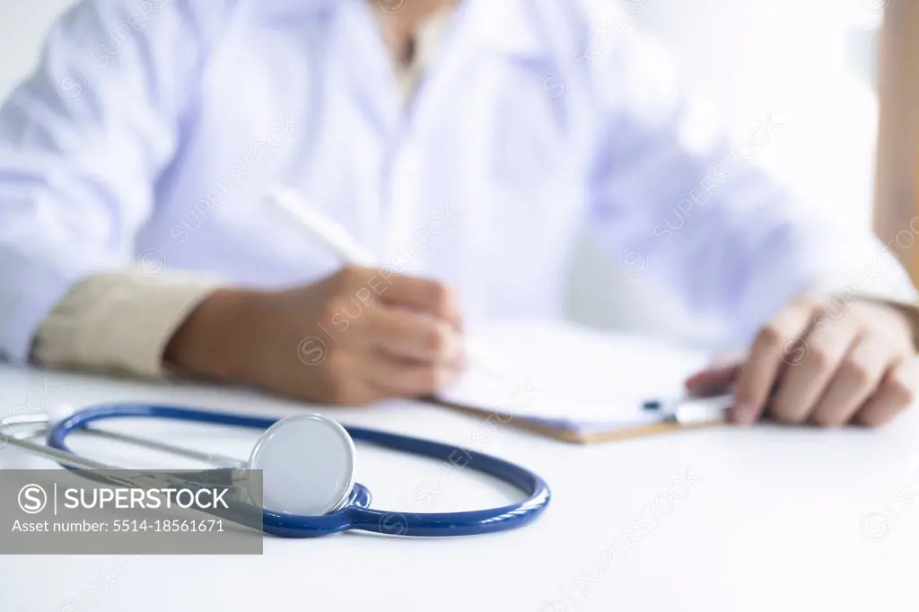 Stethoscope and clip board on the doctors workplace.