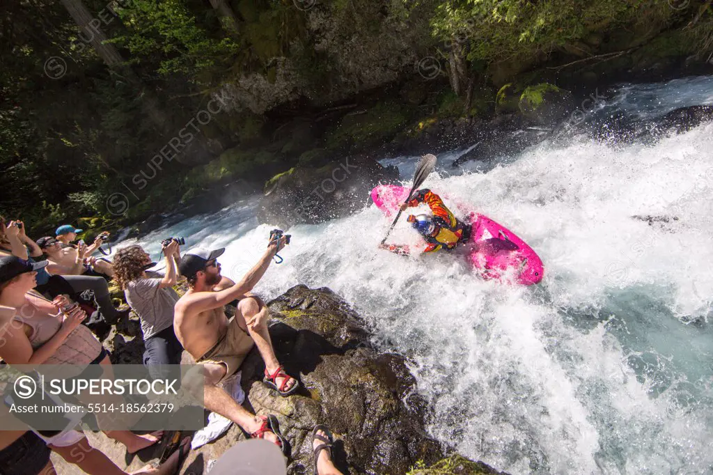 Whitewater kayaking waterfall with crowd