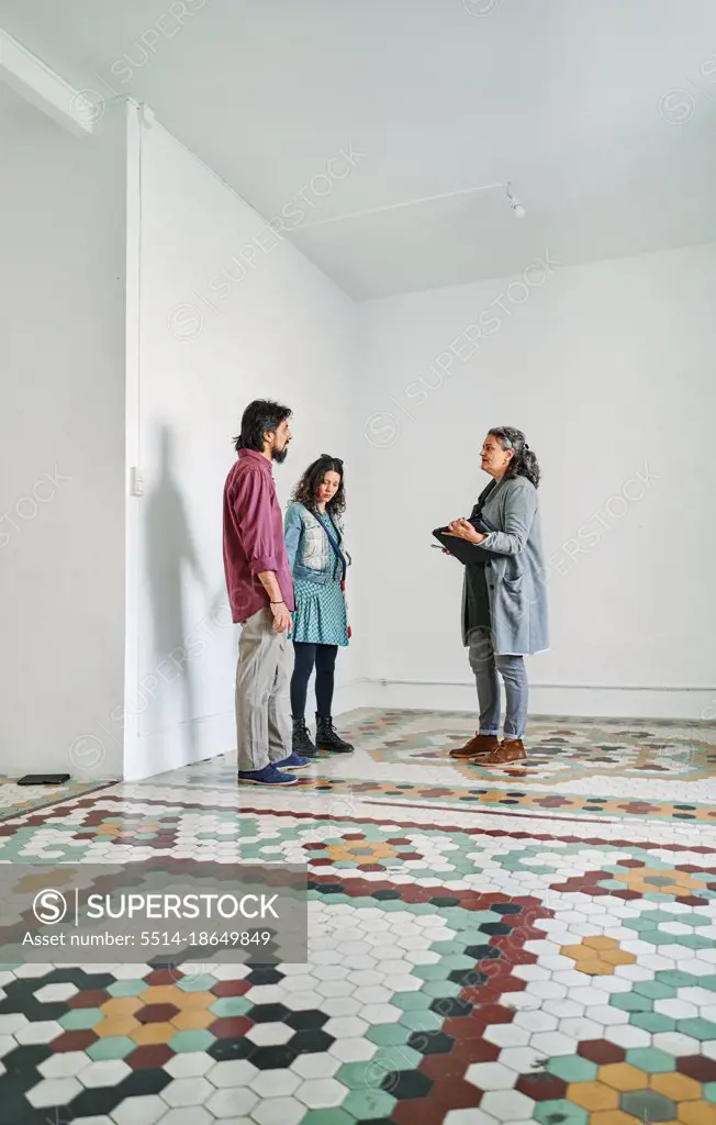 Diverse couple and real estate agent examining rental options