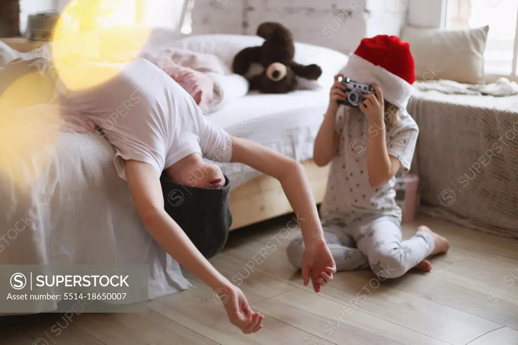 Children are photographed in a bright interior.