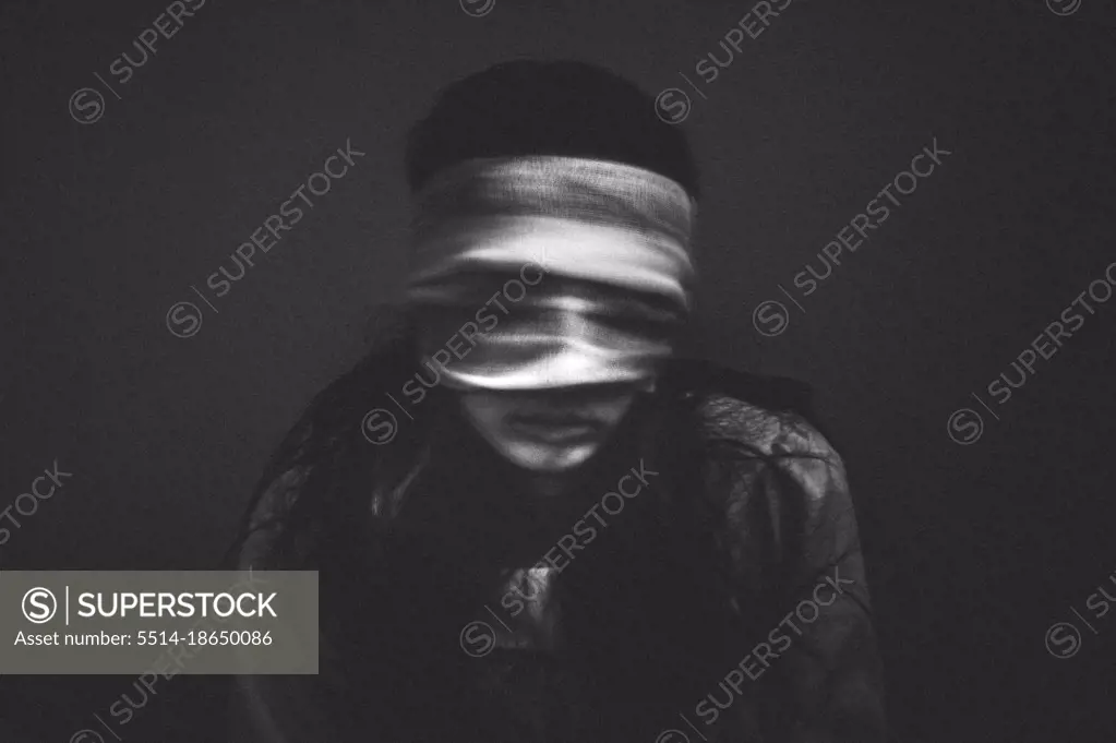 Portrait of creepy girl with bandages over her eyes