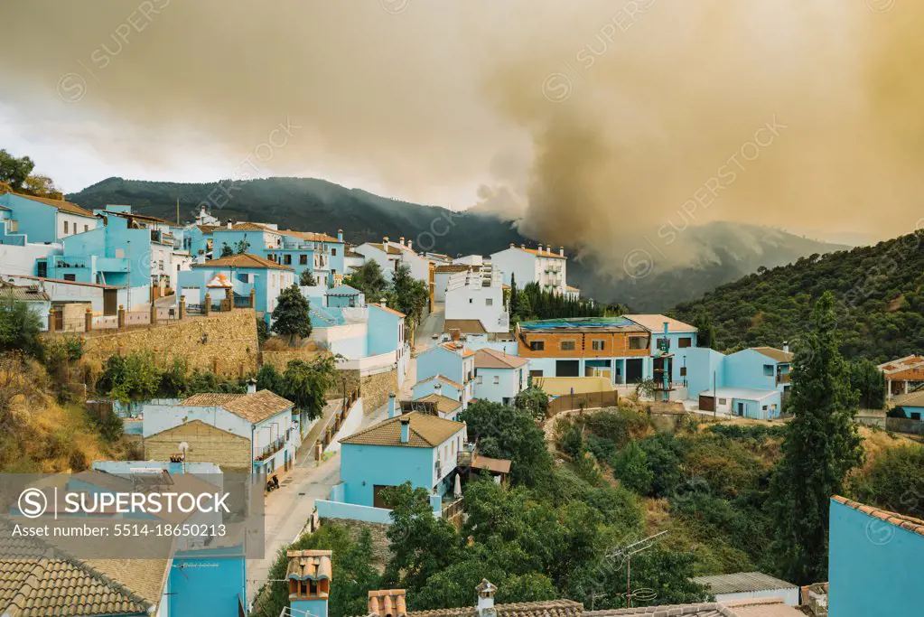 Disaster, wild fire. Town in Spain evacuated. Nearby forest fire.