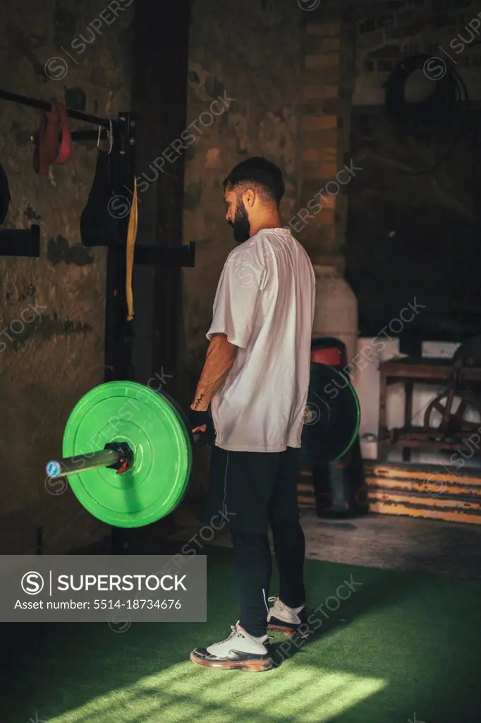 Boy lifting weights in his home gym