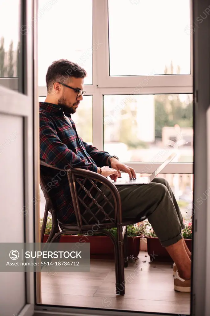 Man using laptop computer while working at home