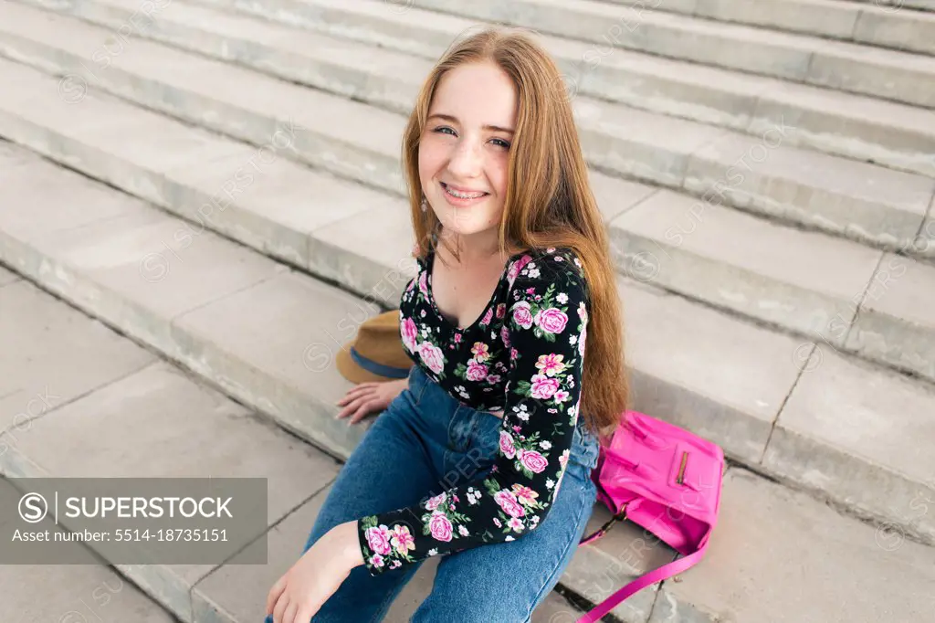 Teenage girl lying on the stairs with accessories