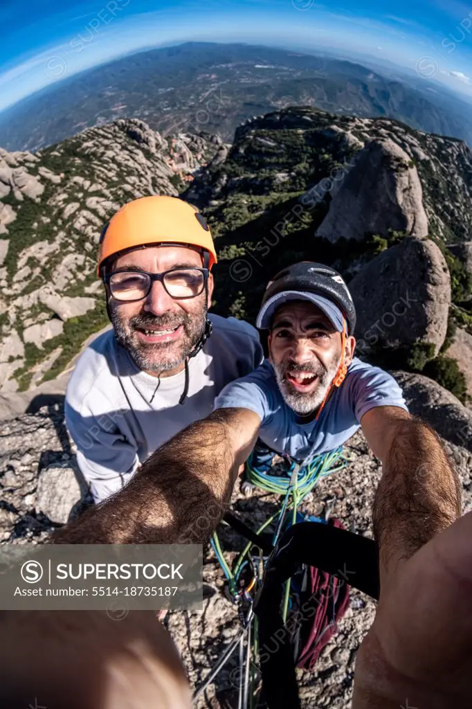 two  veteran climbers selfie at summit