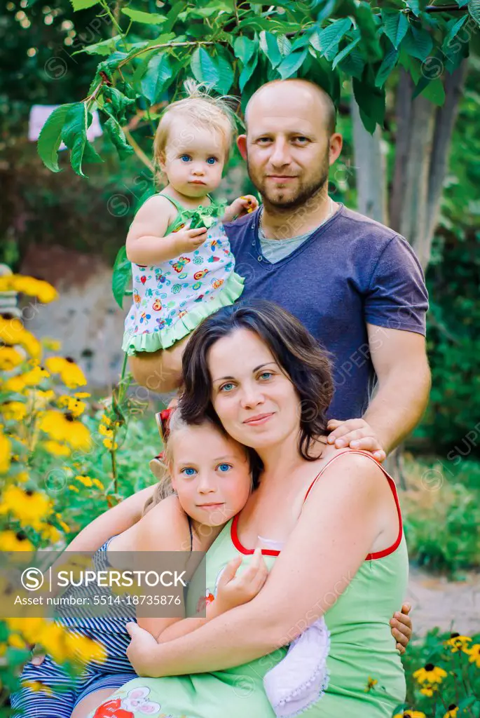 Portrait Of Happy Family In Garden At Home