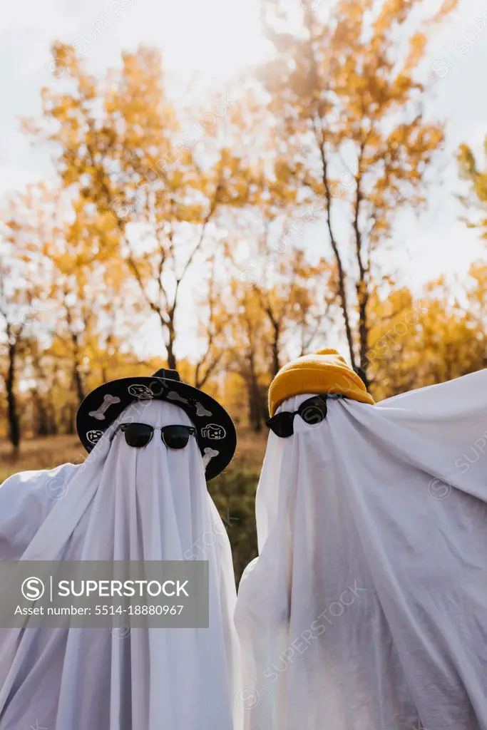 Two people dressed as ghosts looking directly into camera