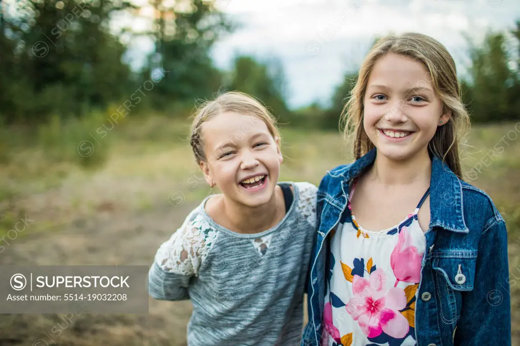 Best girlfriends, laughing and smiling outdoors in nature.