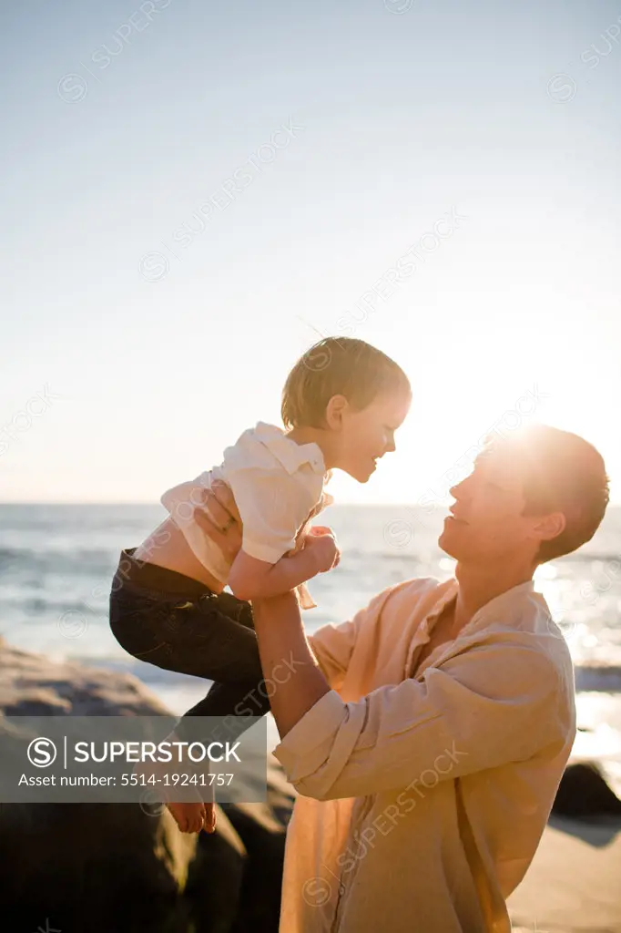 Dad Lifting Up Son at Sunset on Beach in San Diego