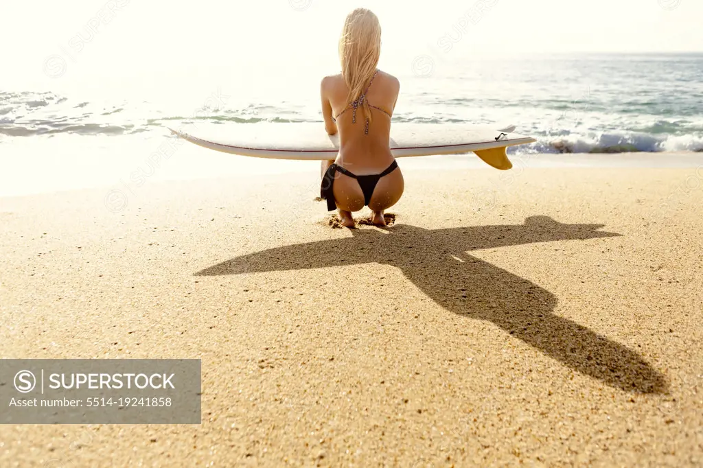 Surfer girl checking out the waves