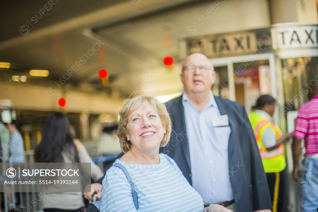 seniors waiting for taxi at airport