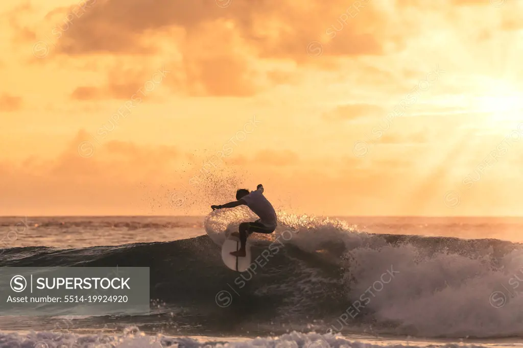 Surfer at sunset time, Maldives