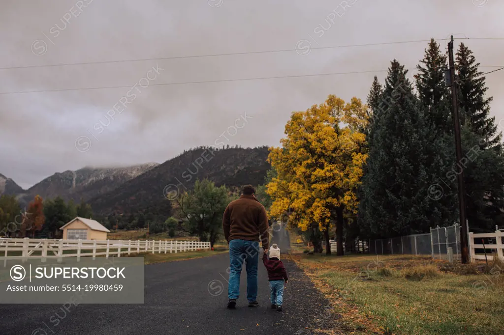 dad and daughter taking a walk outdoors in the autumn with mount