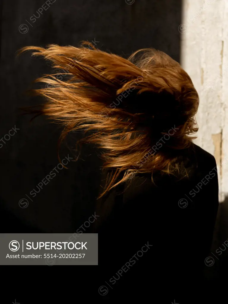 The wind blows girl's hair. - SuperStock