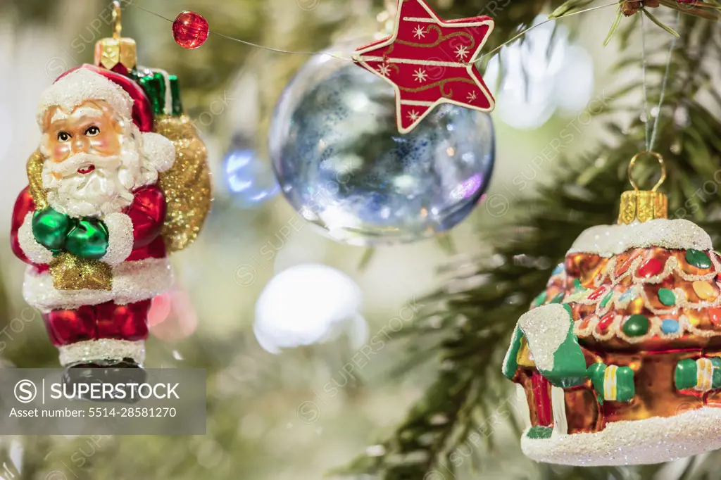 House and Santa Claus hanging on Christmas tree, Munich, Germany