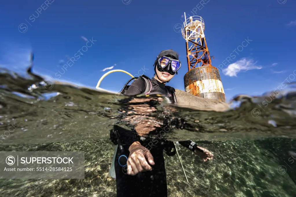 Diver surfacing at the rocky island of Losin in the Gulf of Thailand