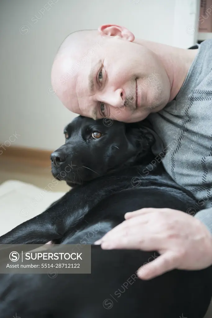 Portrait of man with his dog, smiling