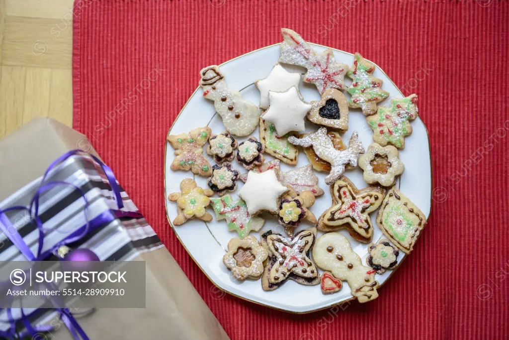 High angle view of gift box and gingerbread Christmas cookies in plate, Bavaria, Germany