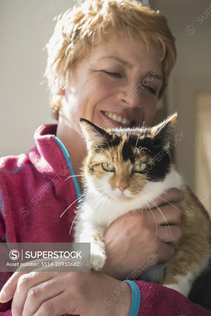 Close-up of mature woman with cat in her arms, Bavaria, Germany