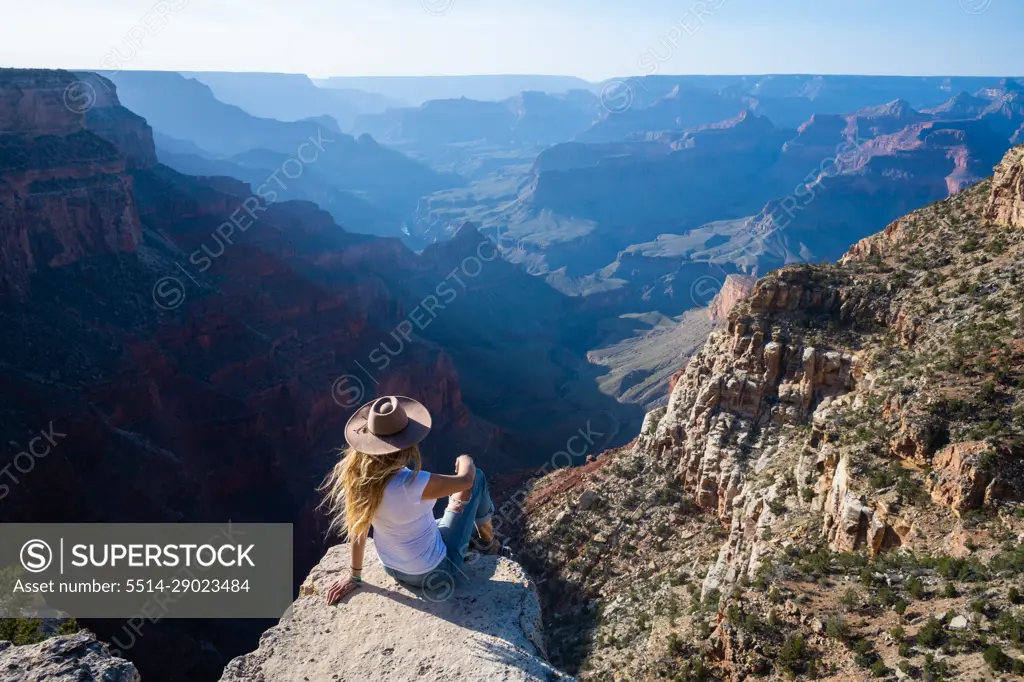 Woman Overlooking Hazy Grand Canyon in Arizona