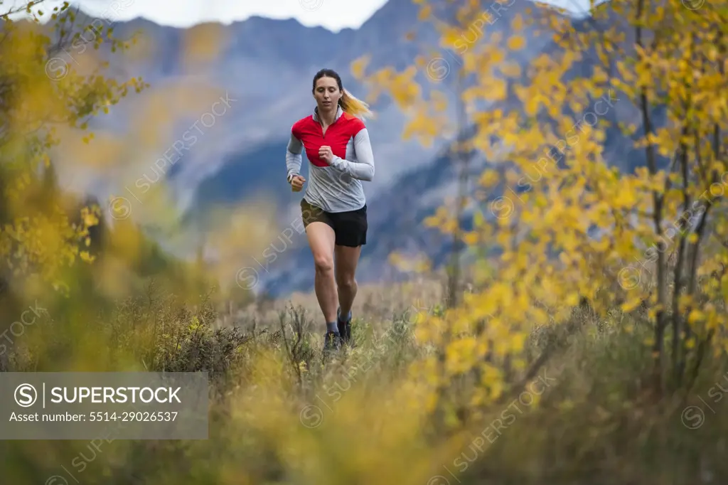 Woman running in forest during autumn