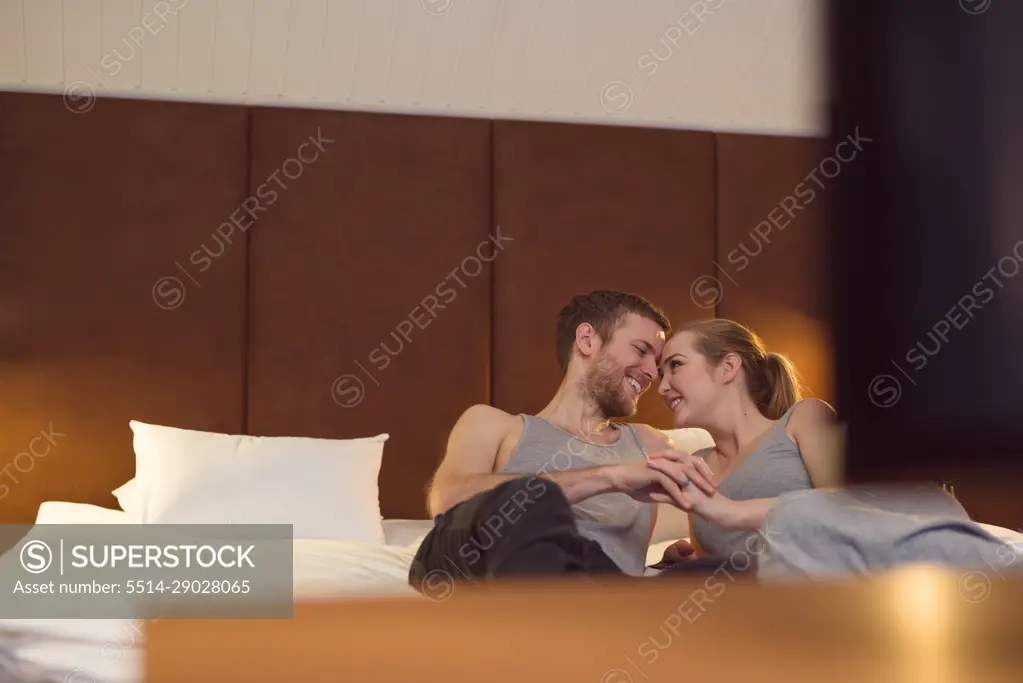 Loving couple chilling on bed