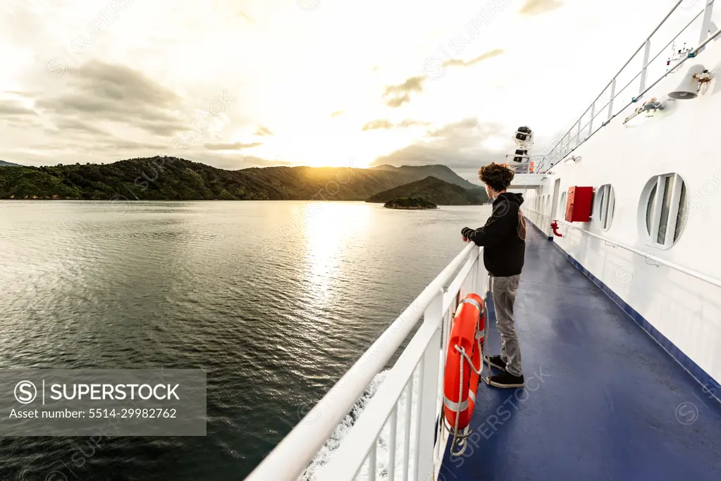 Teenager on boat traveling in between islands in New Zealand