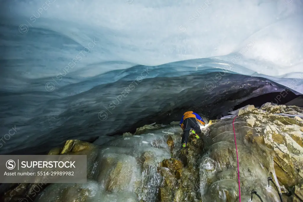 low angle view of Ice climber climbing below glacier