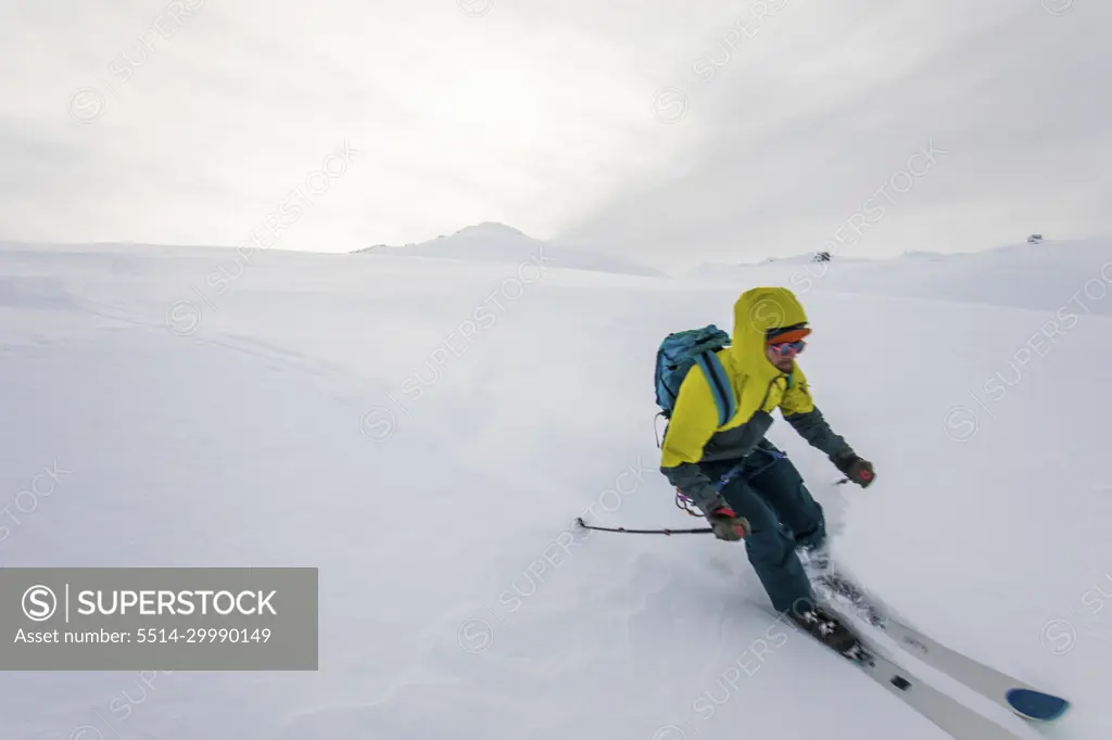 Skier enjoying fresh tracks on a remote mountain in Canada