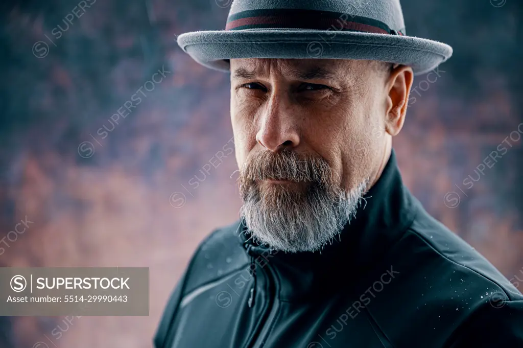 Portrait an attractive middle-aged man with a gray beard. - SuperStock