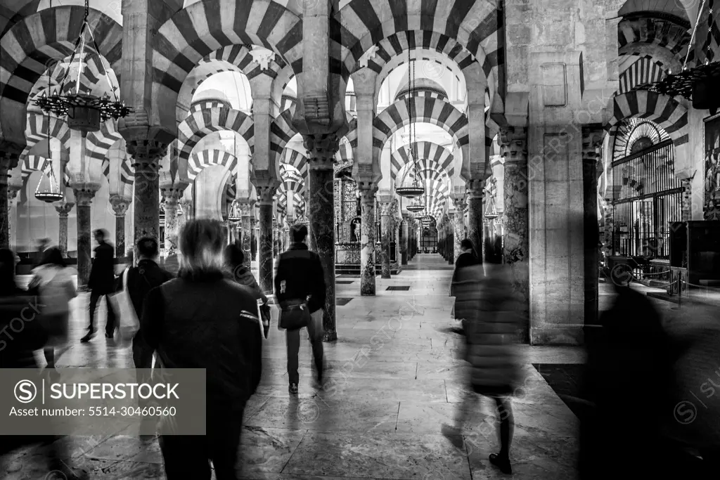 tourists in the mosque of cordoba in spain