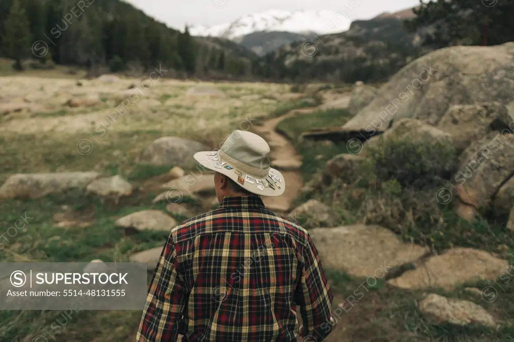 A retired man walks along a trail in Rocky Mountain National Park, CO.