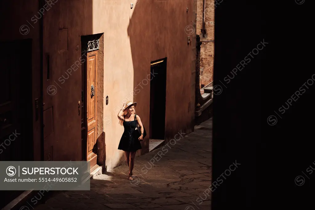 Female tourist walking on narrow street