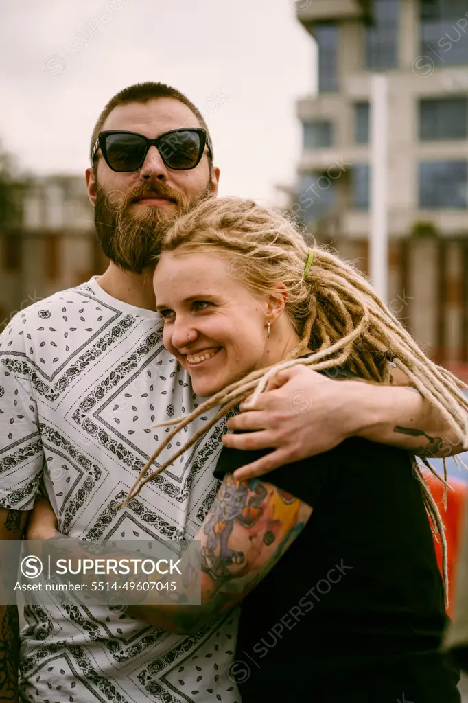 A young couple in love hugs and kisses.