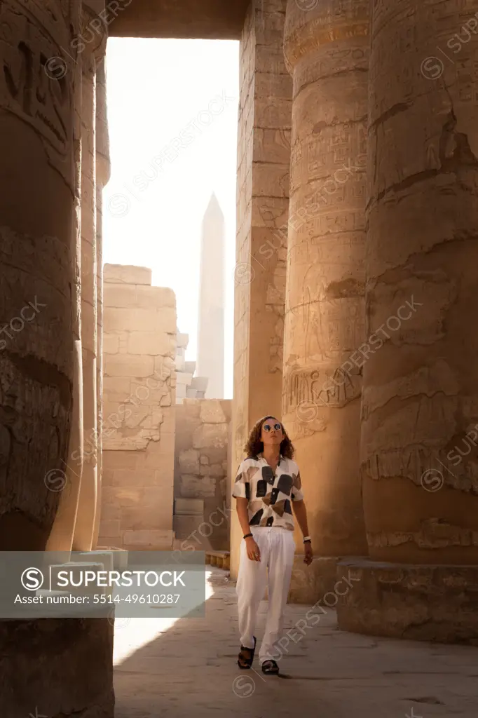 Man with sunglasses, walking around the Hypostyle hall, Karnak Temple