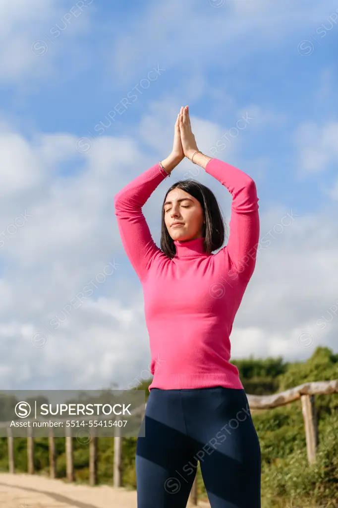 Young woman doing yoga in the park, healthy lifestyle