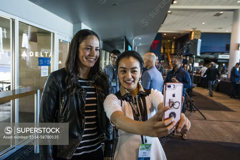 Fangirl taking selfie with female athlete, Seattle, Washington, USA