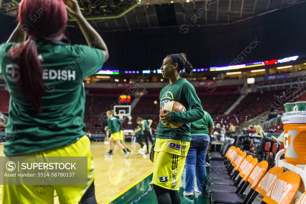 Female basketball players warming up before game, Seattle, Washington, USA