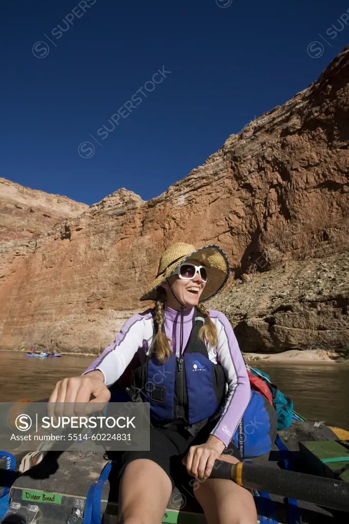 A woman rowing a raft in the Grand Canyon, Arizona.