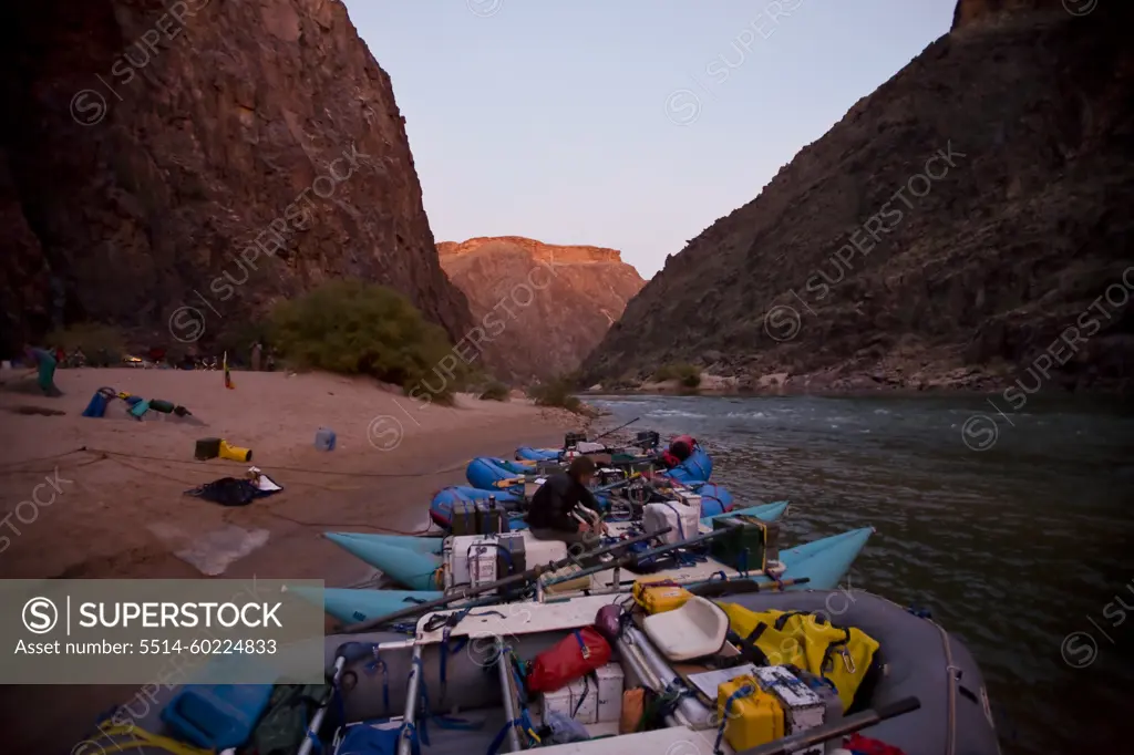 Man sitting with the rafts at camp in the Grand Canyon, Arizona.